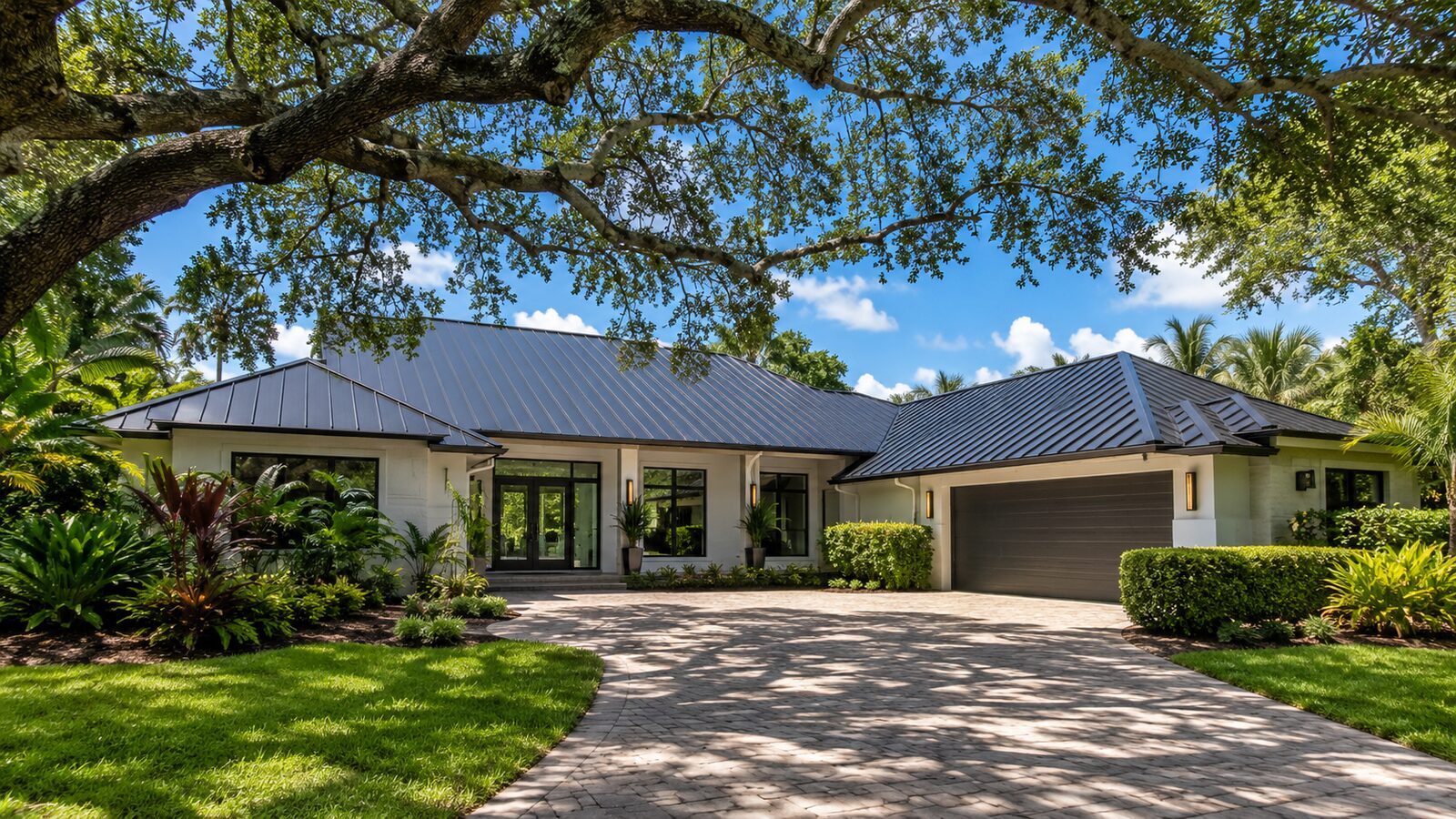 Standing seam metal roof on a Palmetto Bay home framed by tree canopy